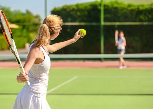 Young Woman Playing Tennis on Court